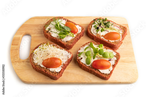 Red beet bread sandwiches with cream cheese, tomatoes and microgreen isolated on white. side view.