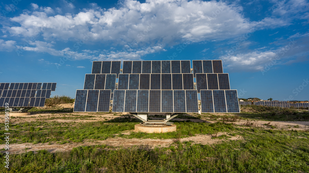 Solar panel photovoltaic in solar farm with cloudy sky and green grass Solar panel photovoltaic in solar farm with cloudy sky and green grass