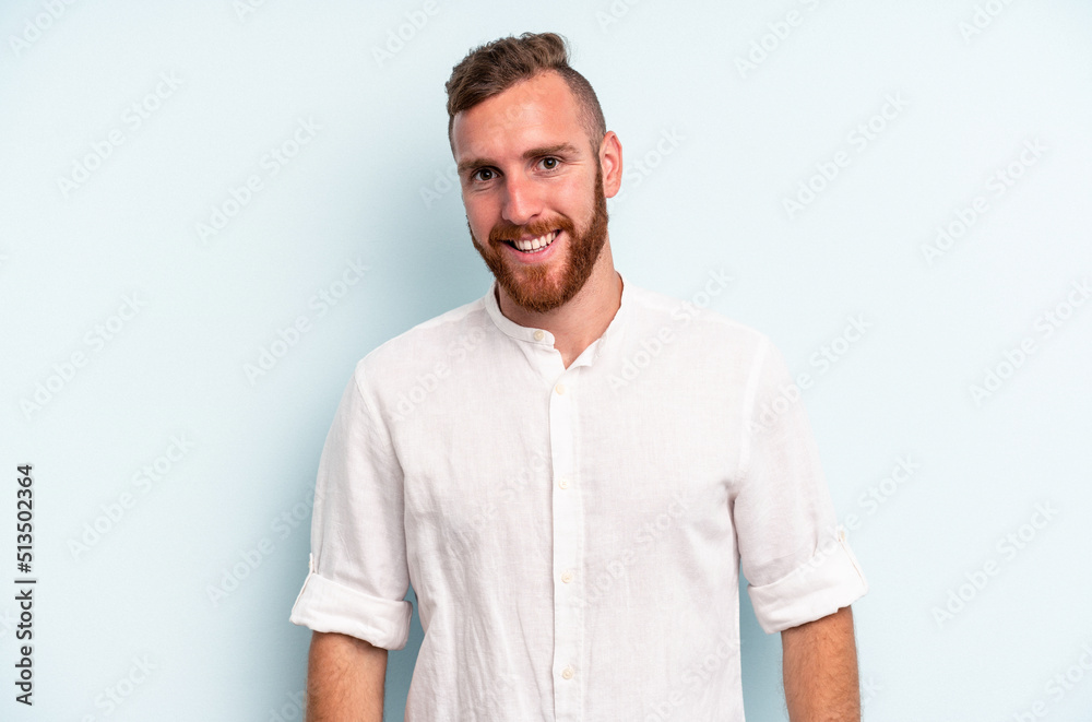Young caucasian man isolated on blue background happy, smiling and cheerful. Young caucasian man isolated on blue background happy, smiling and cheerful.