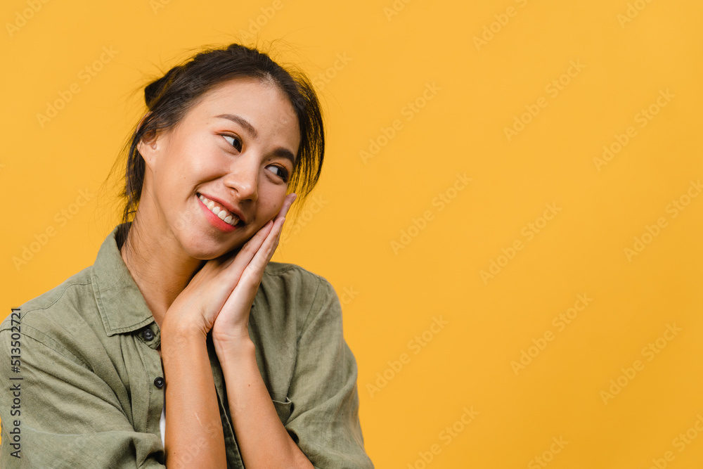Portrait of young Asia lady with positive expression, smile broadly, dressed in casual clothing over yellow background. Happy adorable glad woman rejoices success. Facial expression concept. Portrait of young Asia lady with positive expression, smile broadly, dressed in casual clothing over yellow background. Happy adorable glad woman rejoices success. Facial expression concept.
