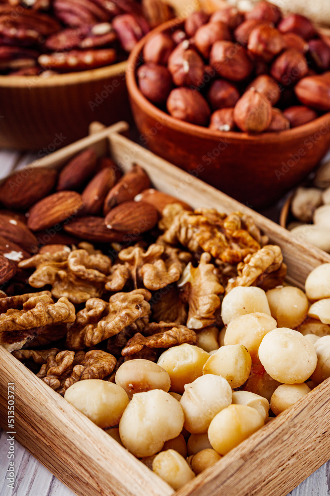 set of different nuts on a white wooden rustic background set of different nuts on a white wooden rustic background