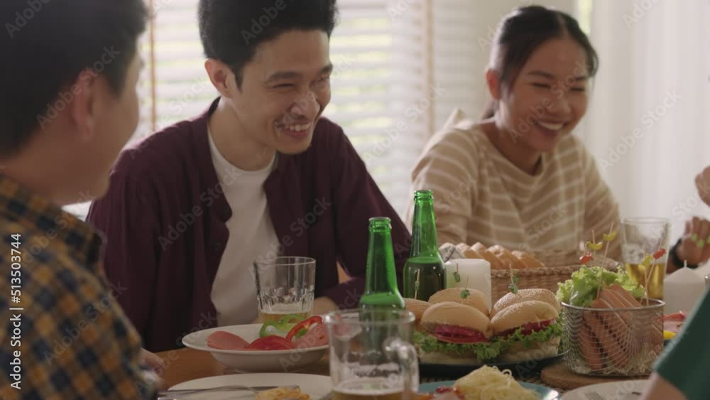Happy hour good warm summer time diner indoor home. Group of asia people young adult friend man and woman sit at dining table joy fun talk or eat food and drink beer alcohol bottle glass inside house. Happy hour good warm summer time diner indoor home. Group of asia people young adult friend man and woman sit at dining table joy fun talk or eat food and drink beer alcohol bottle glass inside house.