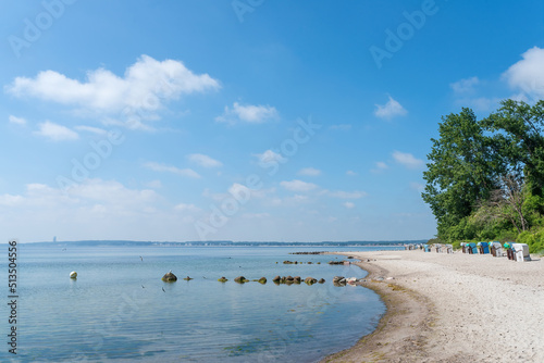 Fototapeta Naklejka Na Ścianę i Meble -  traditional beach chairs on baltic sea beach against blue sky on sunny summer day