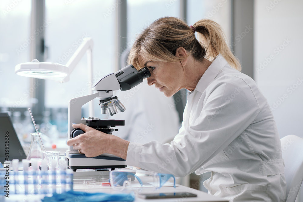 Professional scientist using a microscope Professional scientist using a microscope