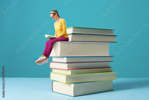 Tiny woman reading books and learning