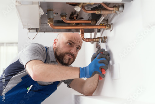 Professional engineer installing a boiler