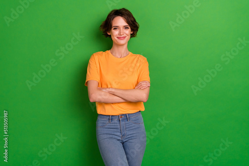 Photo of stunning satisfied glad person crossed hands posing isolated on green color background © deagreez