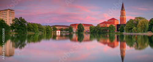 Obraz na płótnie Kiel, Germany. Panoramic cityscape image of downtown Kiel, Germany with Town Hall, Opera House and reflection of the skyline in Small Kiel at sunset. w salonie