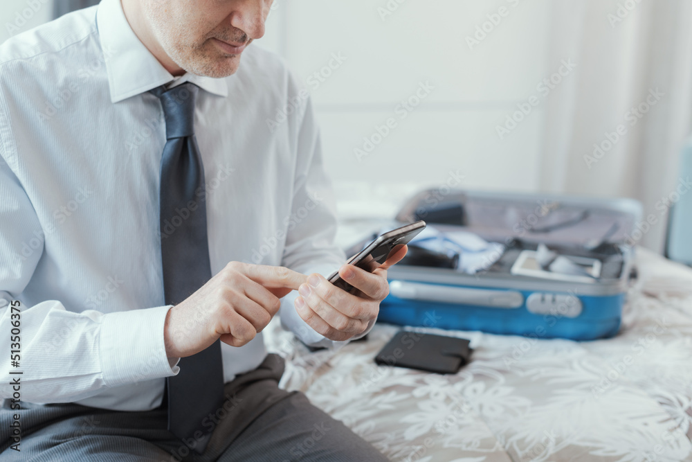 Businessman traveling and using his smartphone Businessman traveling and using his smartphone