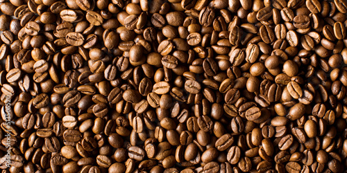 Background of roasted coffee beans full frame. A coffee-themed banner.