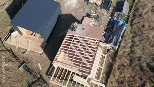 Aerial view of wooden frame house in the Scandinavian style barnhouse under construction in the mountains. photo