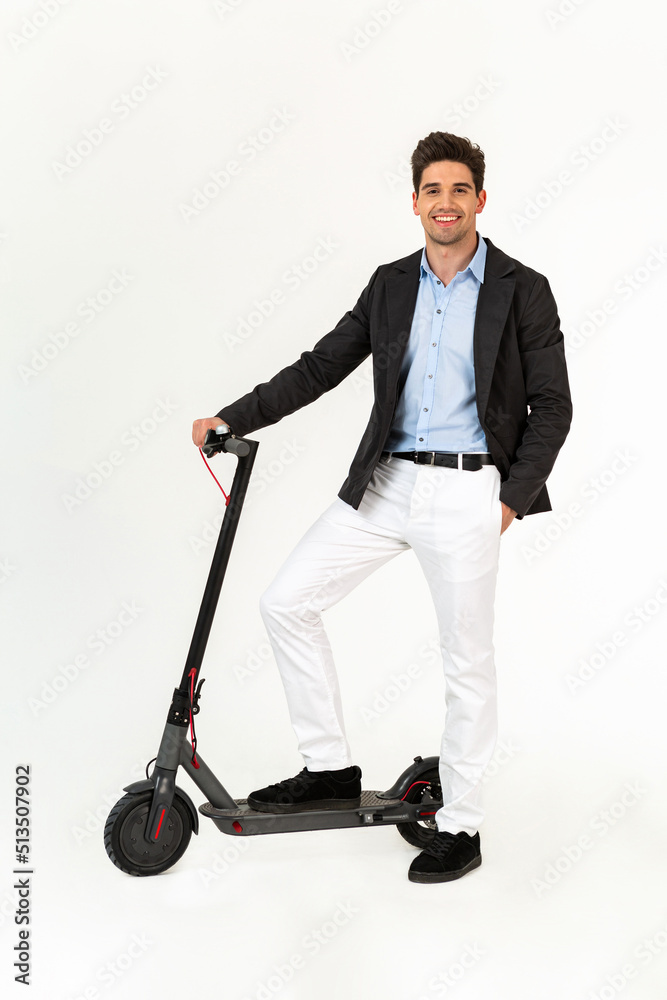 handsome man riding on electic kick scooter isolated on white studio background handsome man riding on electic kick scooter isolated on white studio background