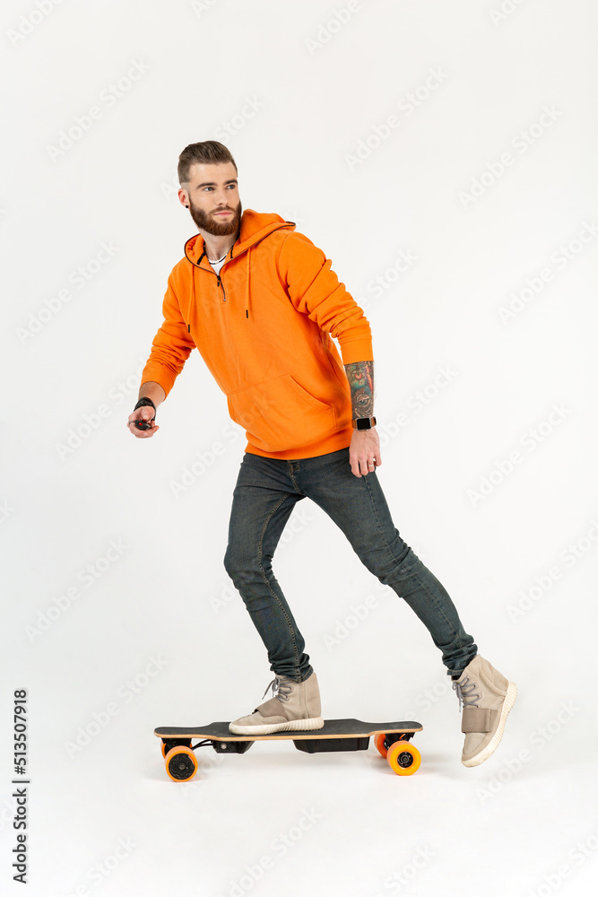 young hipster style man skateboarding on electric skateboard young hipster style man skateboarding on electric skateboard