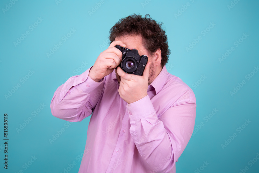 Funny fat man and camera. A young attractive guy is taking pictures. Funny fat man and camera. A young attractive guy is taking pictures.