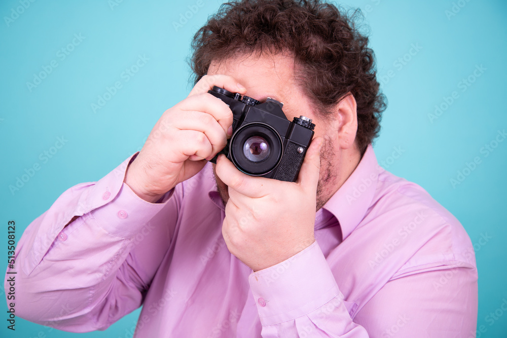 Funny fat man and camera. A young attractive guy is taking pictures. Funny fat man and camera. A young attractive guy is taking pictures.