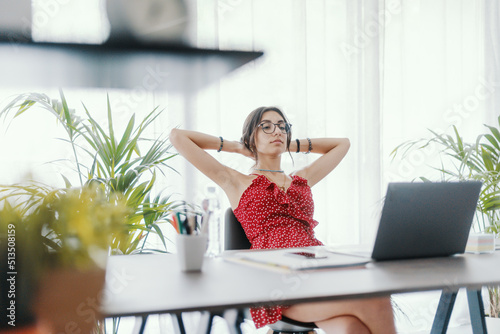 Woman sitting at desk and relaxing