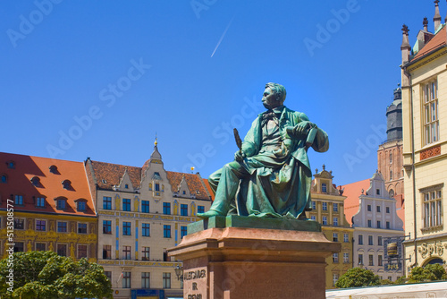 Old Statue of the Polish poet, playwright and comedy writer Aleksander Fredro on the Market Square in front of the Town Hall of Wroclaw, Poland photo