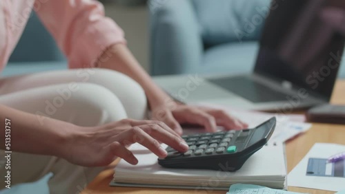 Close Up Of Woman'S Hand Calculating Money By Calculator Before Opening The Purse To Check Money 
 photo