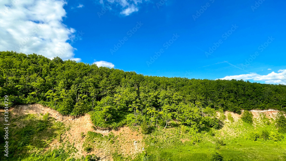 green ravines and plains with small trees