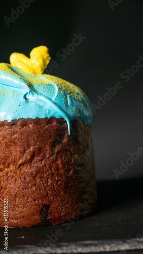 Homemade tasty easter cake with sugar glaze and sprinkles. Homemade easter bread on black background photo