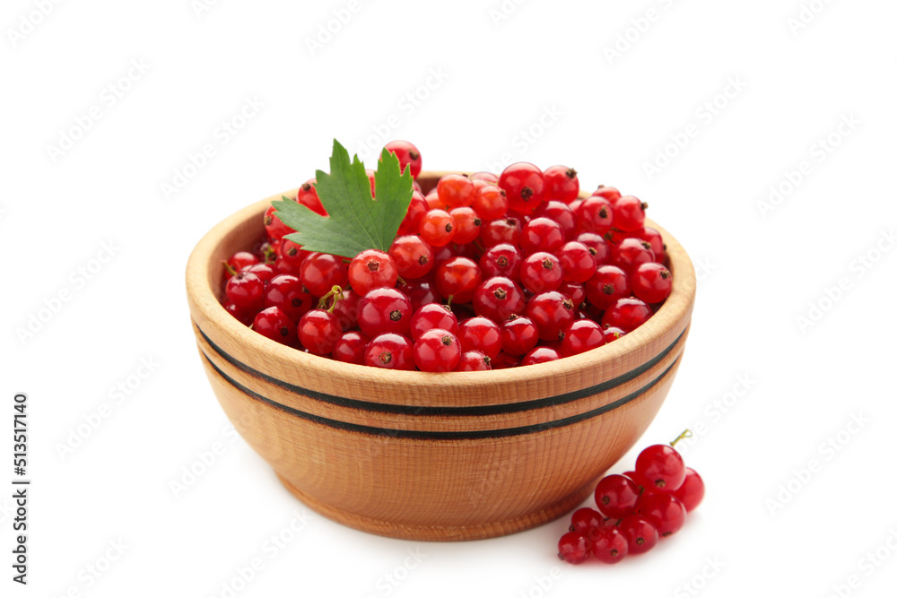 Red currant berries in a wooden bowl with leaf isolated on white background Red currant berries in a wooden bowl with leaf isolated on white background