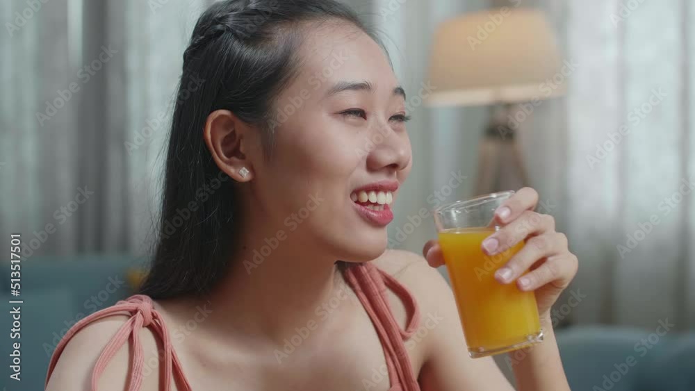 Close Up Of Smiling Asian Woman Enjoys Drinking Orange Juice While Having Healthy Food At Home
Close Up Of Smiling Asian Woman Enjoys Drinking Orange Juice While Having Healthy Food At Home