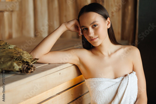 Girl enjoys relaxing in the sauna