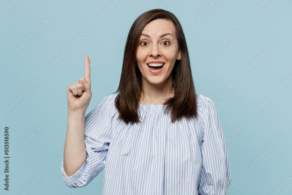 Young insighted smart proactive happy woman she 20s in casual blouse hold index finger up with great new idea isolated on pastel plain light blue background studio portrait People lifestyle concept Young insighted smart proactive happy woman she 20s in casual blouse hold index finger up with great new idea isolated on pastel plain light blue background studio portrait People lifestyle concept