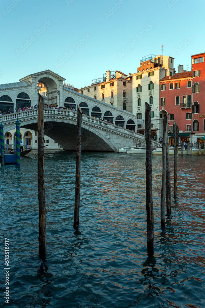 Gondola poles in Venice with the Rialto bridge in the background