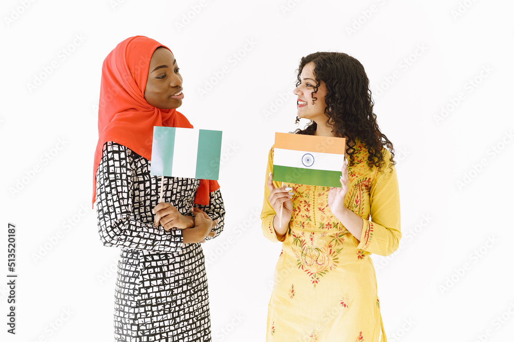 African and Asian women together on white background African and Asian women together on white background