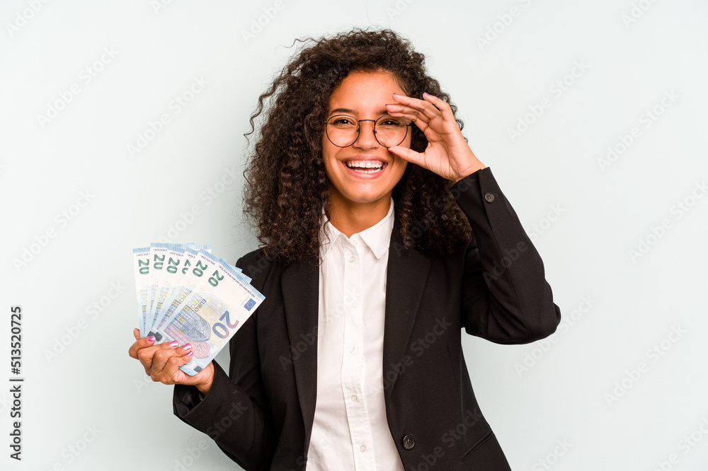 Young business Brazilian woman holding banknotes isolated on white background excited keeping ok gesture on eye. Young business Brazilian woman holding banknotes isolated on white background excited keeping ok gesture on eye.