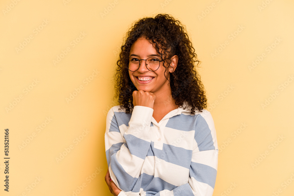Young Brazilian woman isolated on yellow background smiling happy and confident, touching chin with hand. Young Brazilian woman isolated on yellow background smiling happy and confident, touching chin with hand.