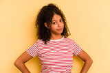 Young Brazilian woman isolated on yellow background confused, feels doubtful and unsure.