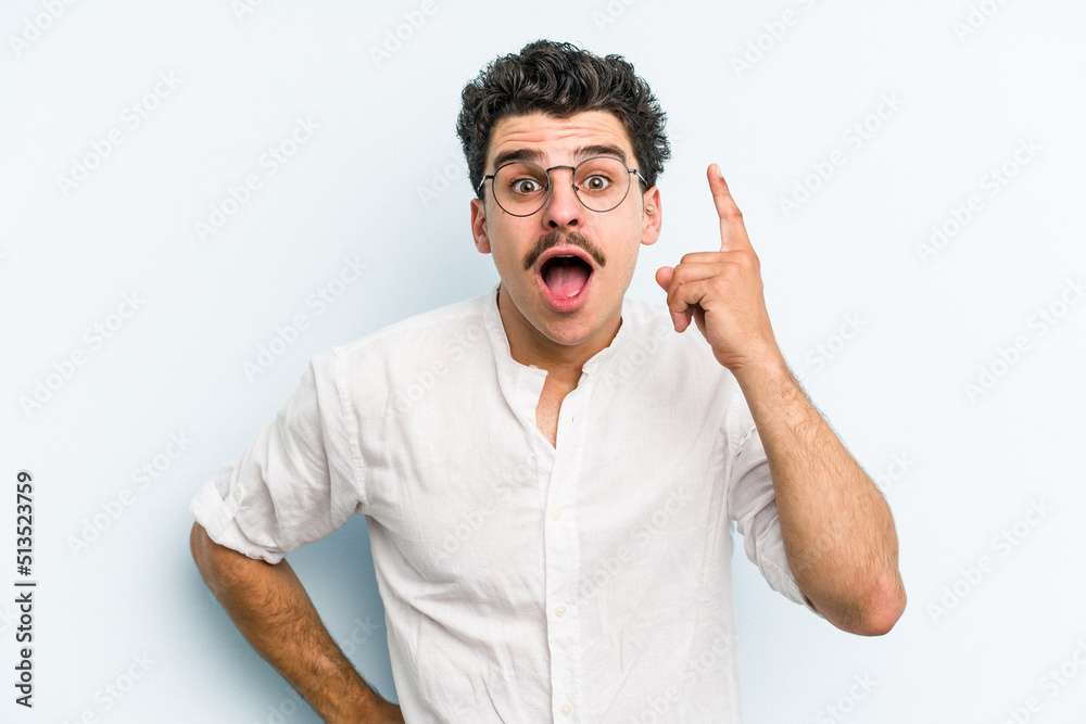 Young caucasian man isolated on blue background having an idea, inspiration concept. Young caucasian man isolated on blue background having an idea, inspiration concept.