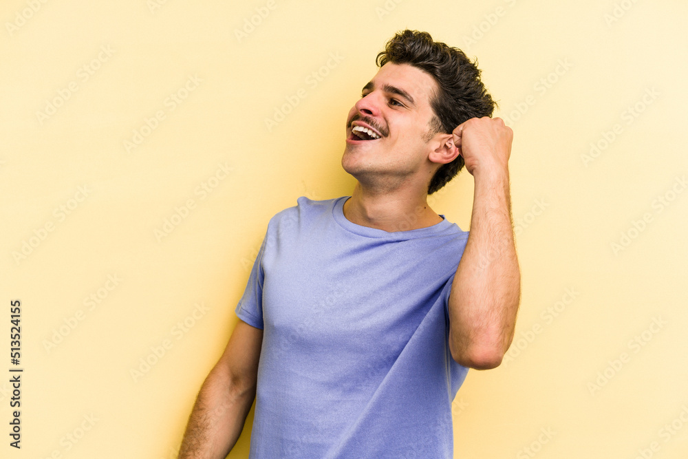 Young caucasian man isolated on yellow background celebrating a victory, passion and enthusiasm, happy expression. Young caucasian man isolated on yellow background celebrating a victory, passion and enthusiasm, happy expression.