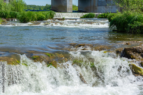 Rapids near the dam of the former hydroelectric power station on the Suenga River photo