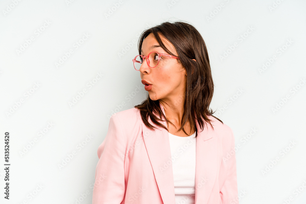 Young hispanic woman isolated on blue background doubting between two options. Young hispanic woman isolated on blue background doubting between two options.