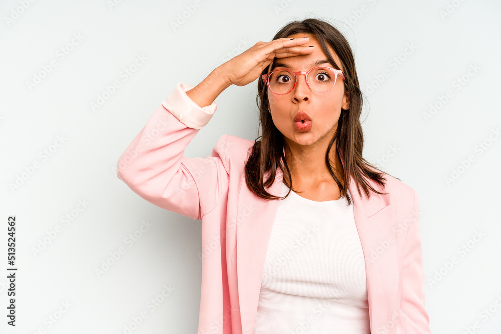 Young hispanic woman isolated on blue background keeping eyes opened to find a success opportunity. Young hispanic woman isolated on blue background keeping eyes opened to find a success opportunity.