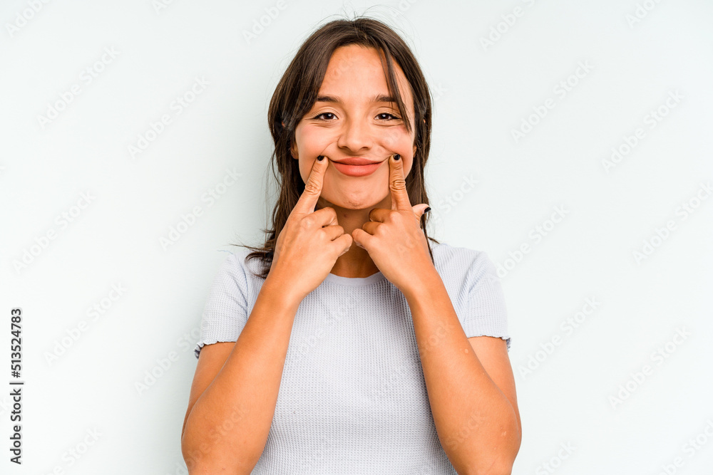 Young hispanic woman isolated on blue background laughs joyfully keeping hands on head. Happiness concept. Young hispanic woman isolated on blue background laughs joyfully keeping hands on head. Happiness concept.