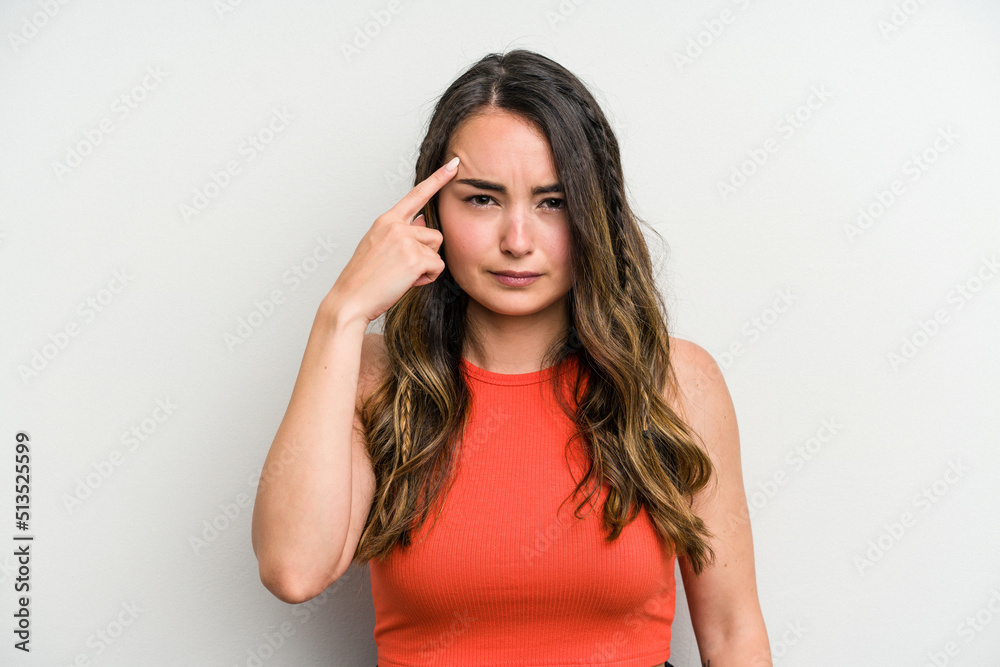 Young caucasian woman isolated on white background pointing temple with finger, thinking, focused on a task. Young caucasian woman isolated on white background pointing temple with finger, thinking, focused on a task.