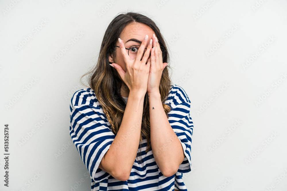 Young caucasian woman isolated on white background blink through fingers frightened and nervous. Young caucasian woman isolated on white background blink through fingers frightened and nervous.