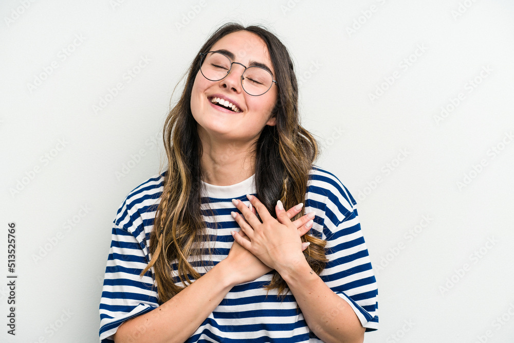 Young caucasian woman isolated on white background has friendly expression, pressing palm to chest. Love concept. Young caucasian woman isolated on white background has friendly expression, pressing palm to chest. Love concept.