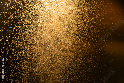 Dark golden bokeh glitter texture background