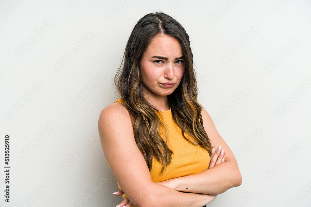 Young caucasian woman isolated on white background frowning face in displeasure, keeps arms folded. Young caucasian woman isolated on white background frowning face in displeasure, keeps arms folded.