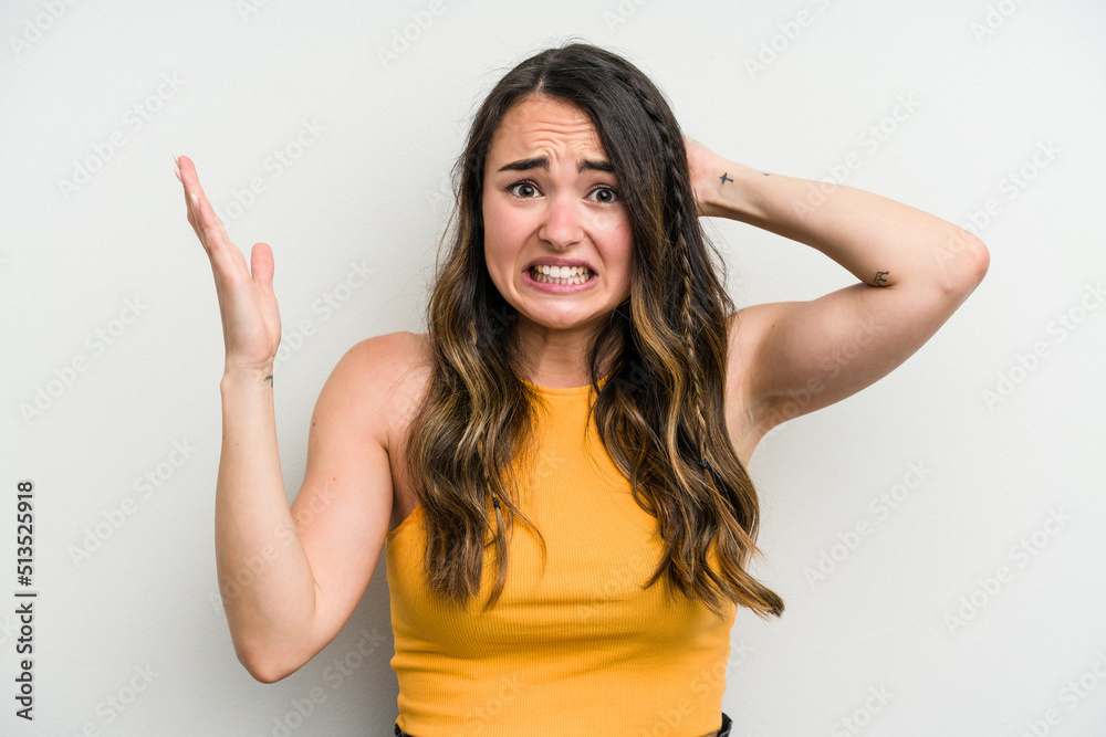 Young caucasian woman isolated on white background screaming with rage.