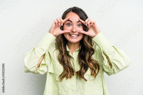 Young caucasian woman isolated on white background keeping eyes opened to find a success opportunity.