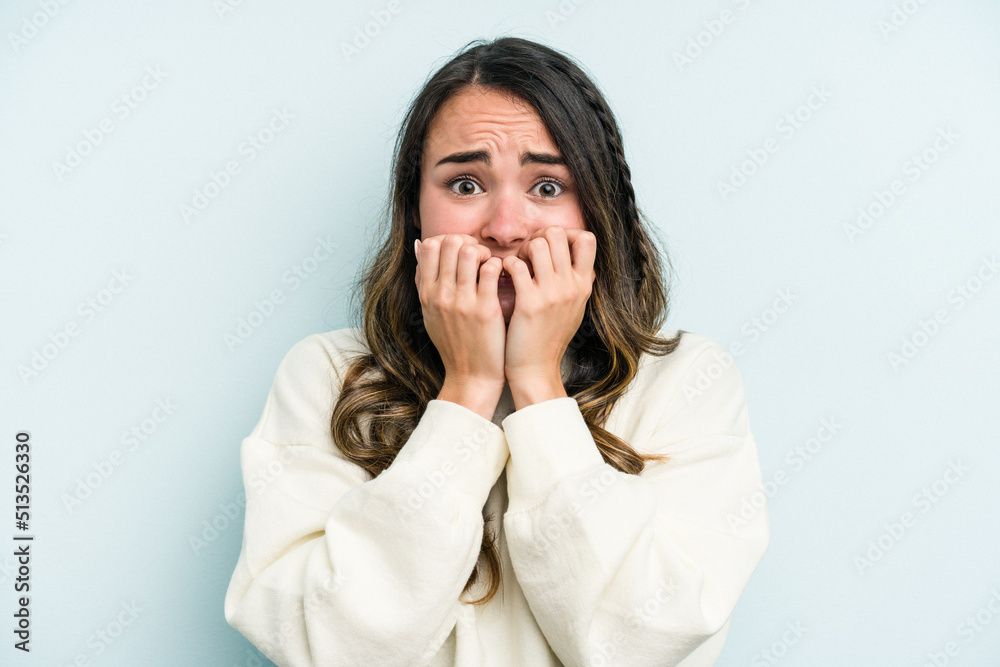 Young caucasian woman isolated on blue background biting fingernails, nervous and very anxious. Young caucasian woman isolated on blue background biting fingernails, nervous and very anxious.
