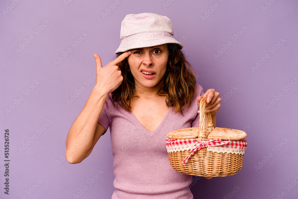 Young caucasian woman going on a picnic isolated on purple background showing a disappointment gesture with forefinger. Young caucasian woman going on a picnic isolated on purple background showing a disappointment gesture with forefinger.