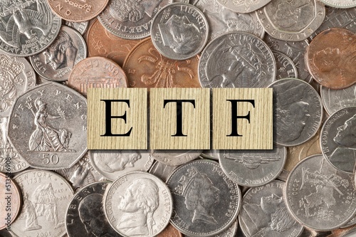 exchange-traded fund (ETF) is a type of pooled investment security. The word is written on money and gold background