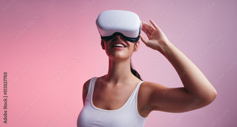 Happy young woman wearing virtual reality goggles Happy young woman wearing virtual reality goggles